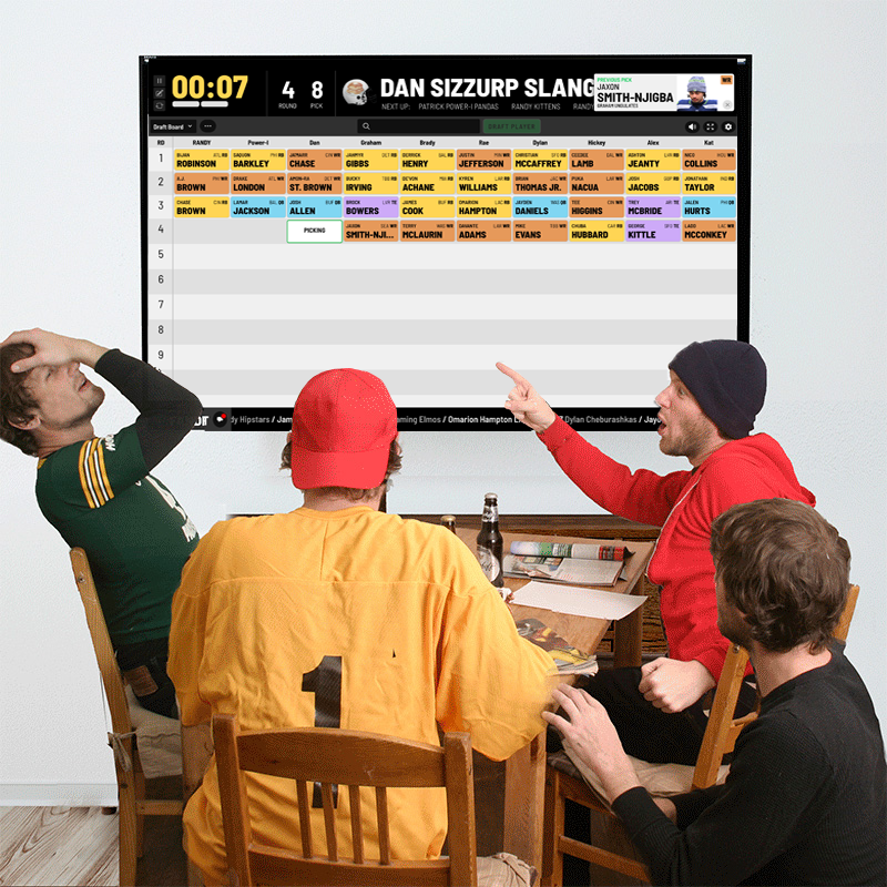 Friends celebrating around the TV at their FanDraft fantasy football draft party